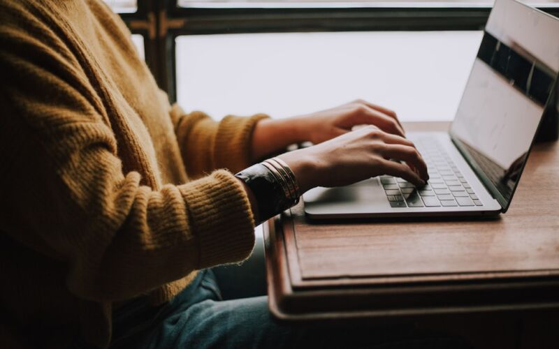 person sitting front of laptop